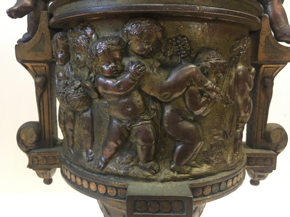 C19th gilt classical metal vase with cherub decoration View II