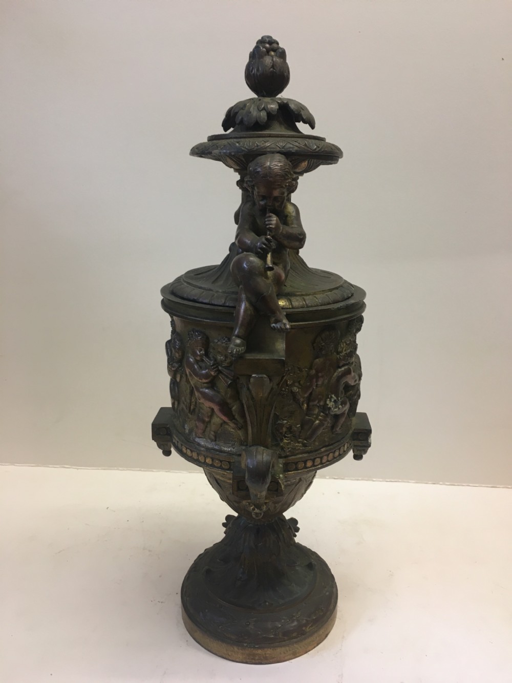C19th gilt classical metal vase with cherub decoration View V