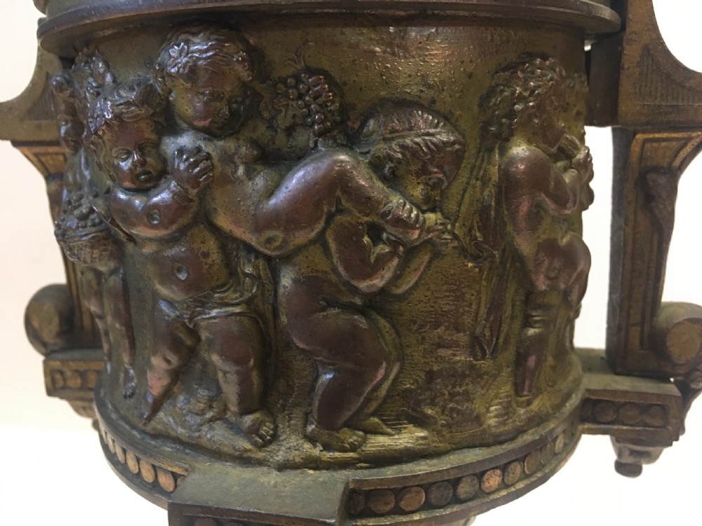C19th gilt classical metal vase with cherub decoration View VII