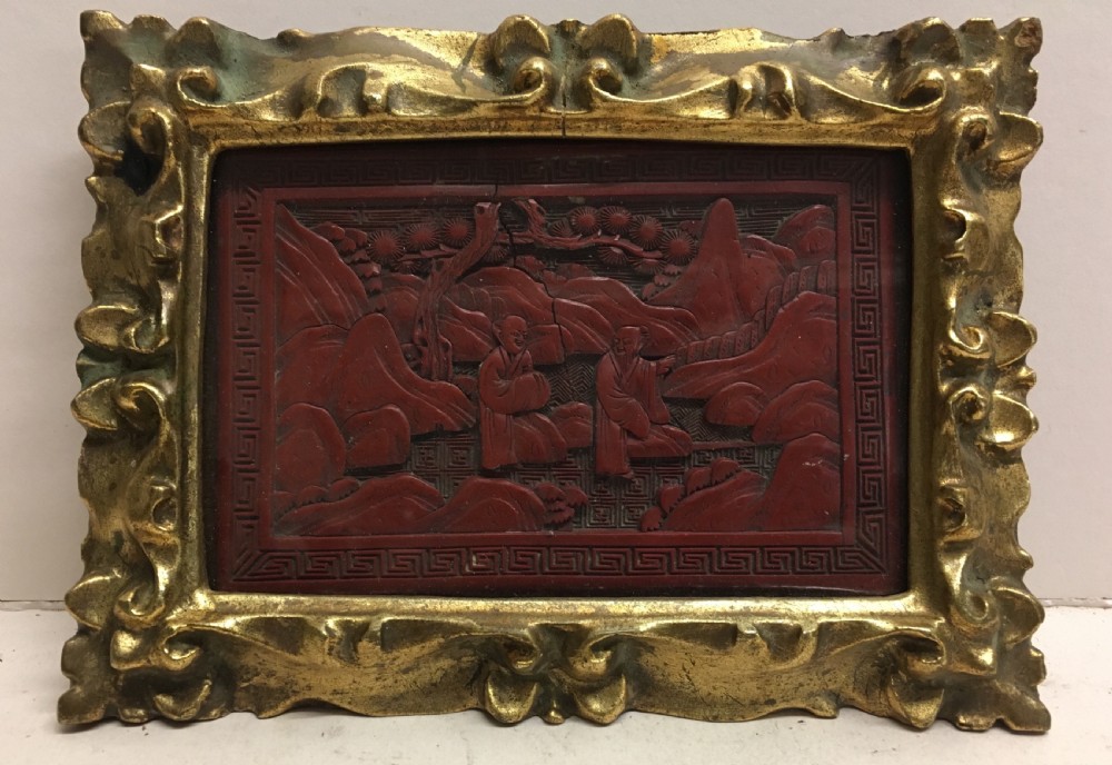 C19th cinnabar lacquered panel in carved gilt wood frame