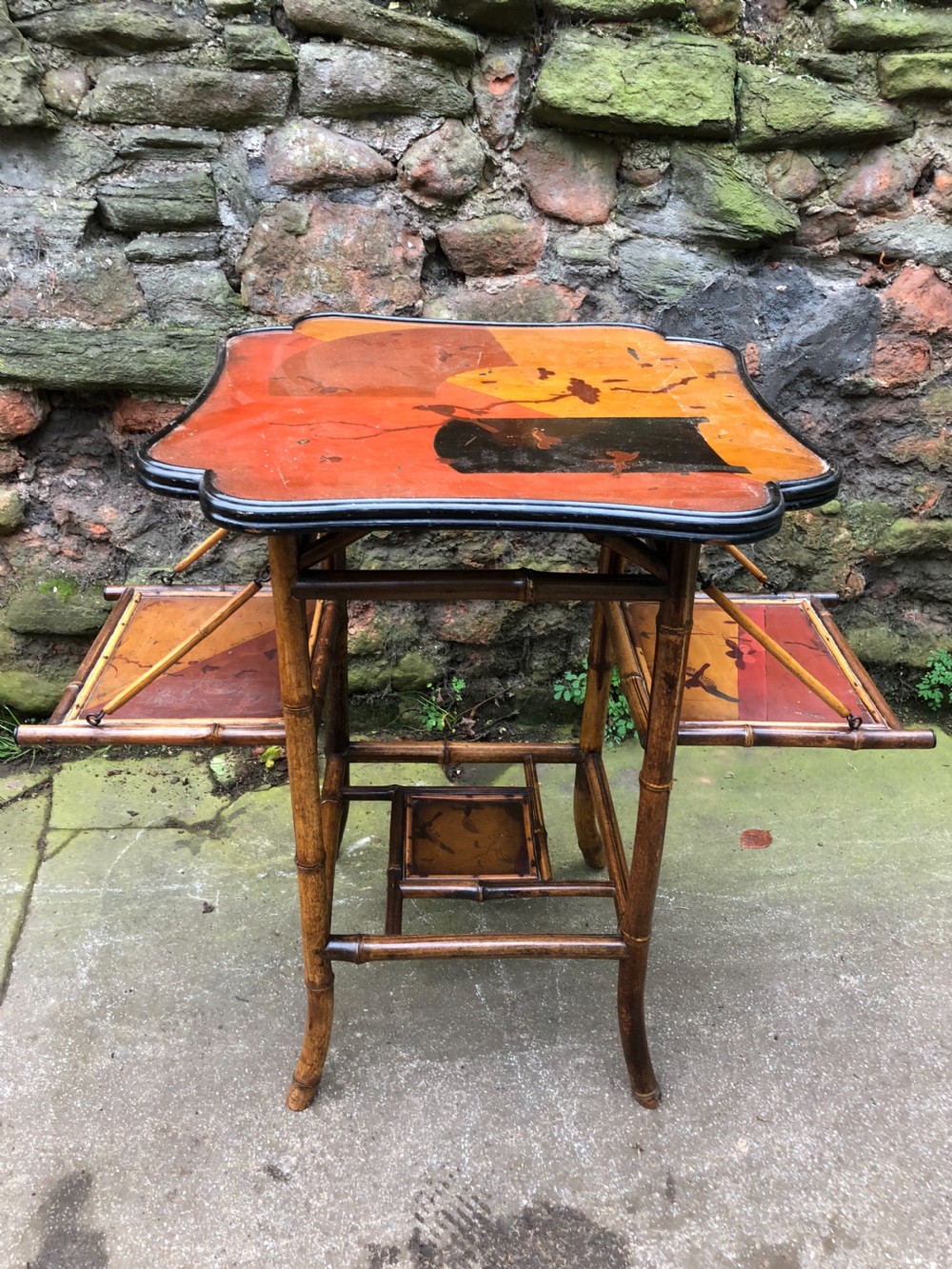 Edwardian lacquered bamboo table with two adjustable shelves