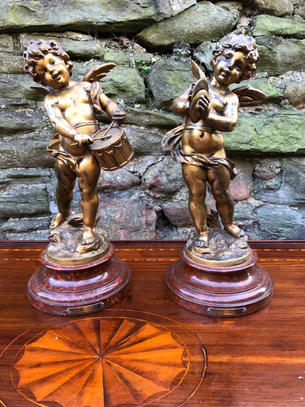 Pair of cherubs playing cymbals and a drum after A Moreau 