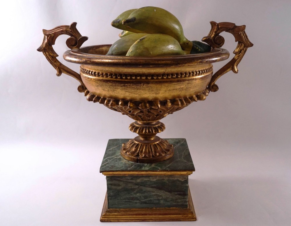 A decorative carved wooden urn 