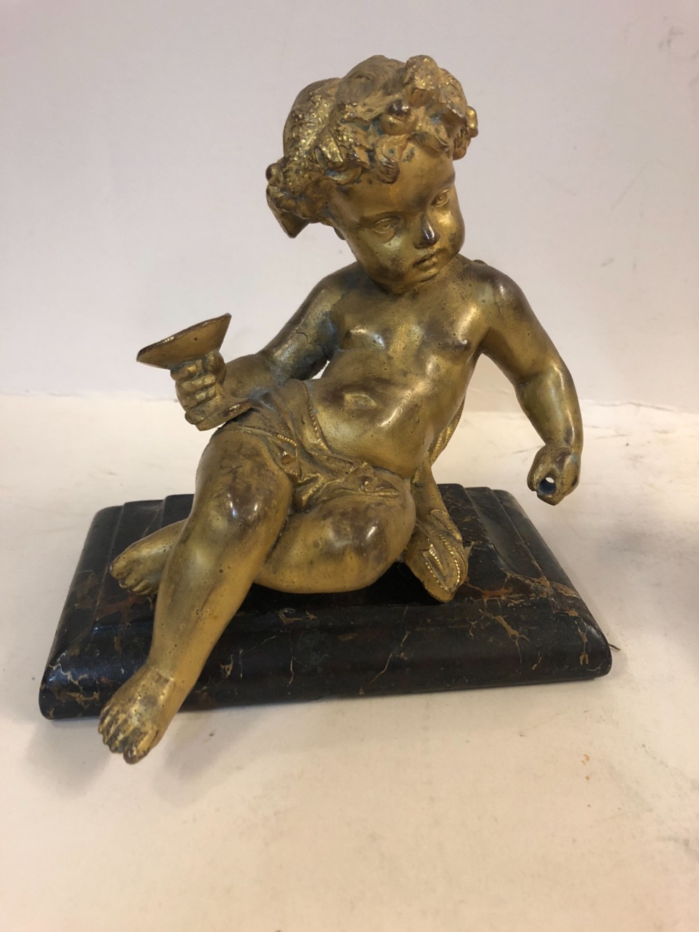 Pair of gilt metal cherub ornaments on marble bases View II