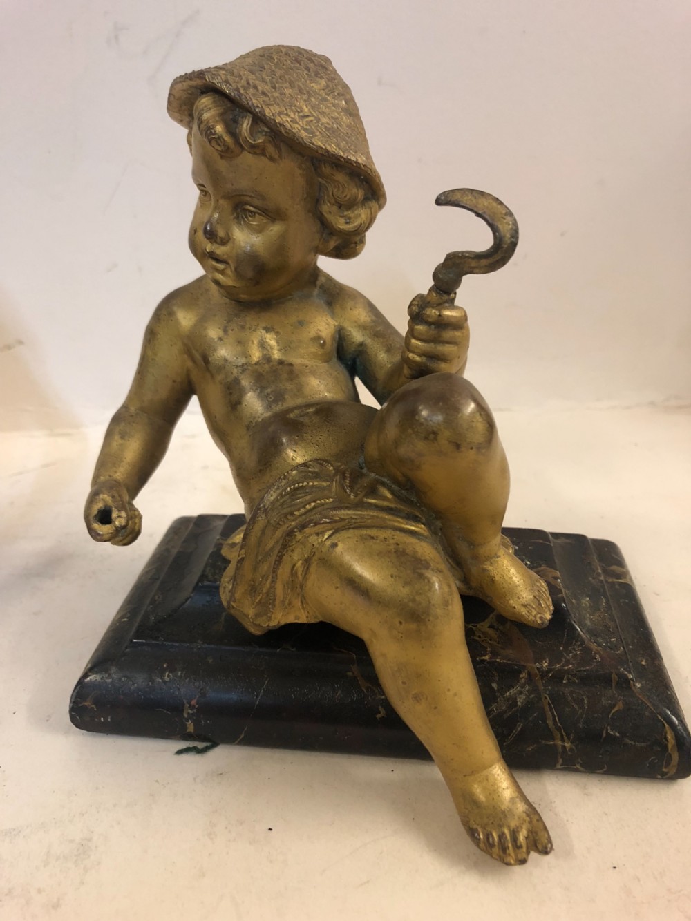 Pair of gilt metal cherub ornaments on marble bases View III