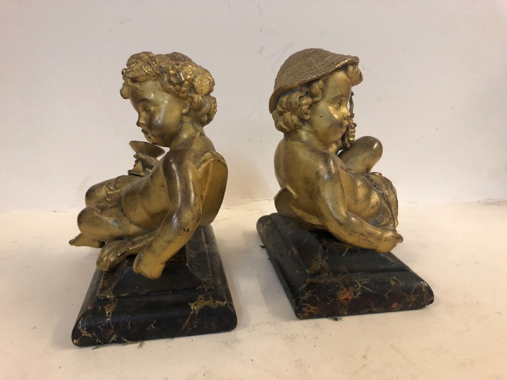 Pair of gilt metal cherub ornaments on marble bases View VI