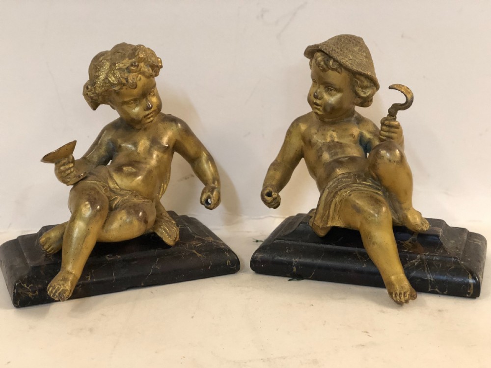 Pair of gilt metal cherub ornaments on marble bases View VII