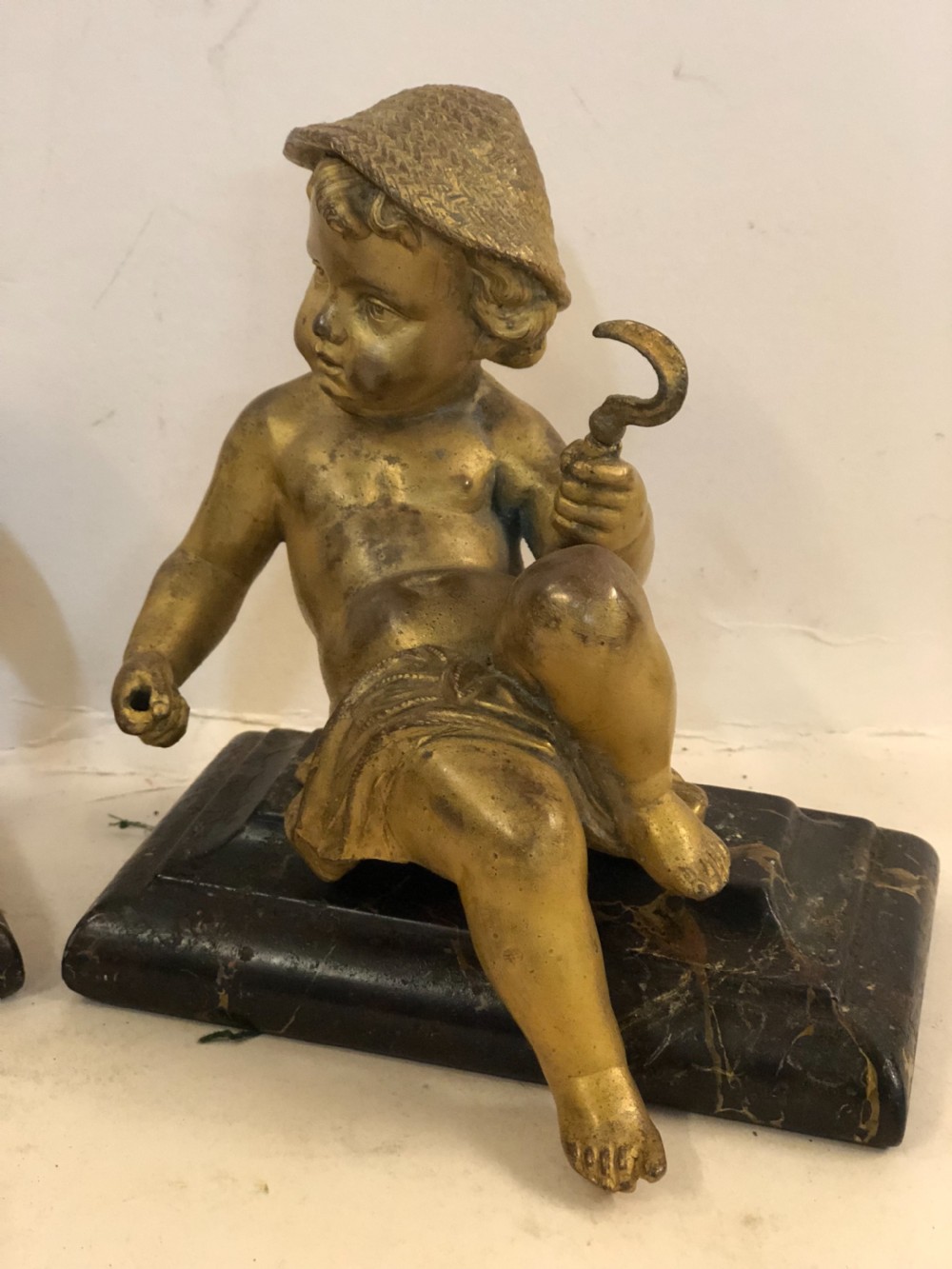 Pair of gilt metal cherub ornaments on marble bases View IX