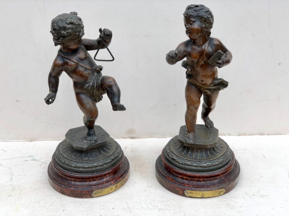 Pair of spelter putti playing instruments 