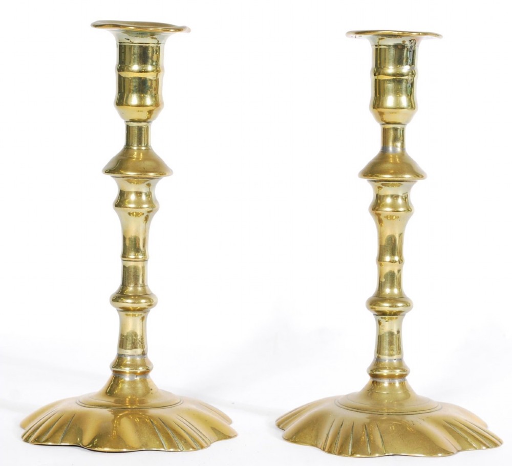 Pair of C18th petal based brass candlesticks 