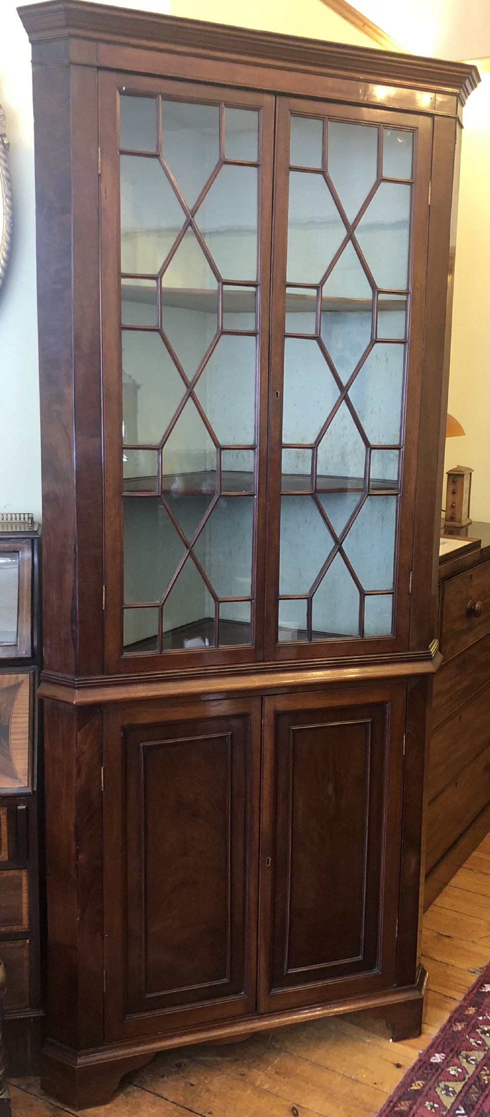 A Georgian full height library corner cupboard