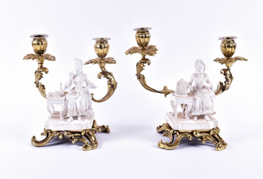 Pair of biscuit figures mounted on double candlesticks and stand 