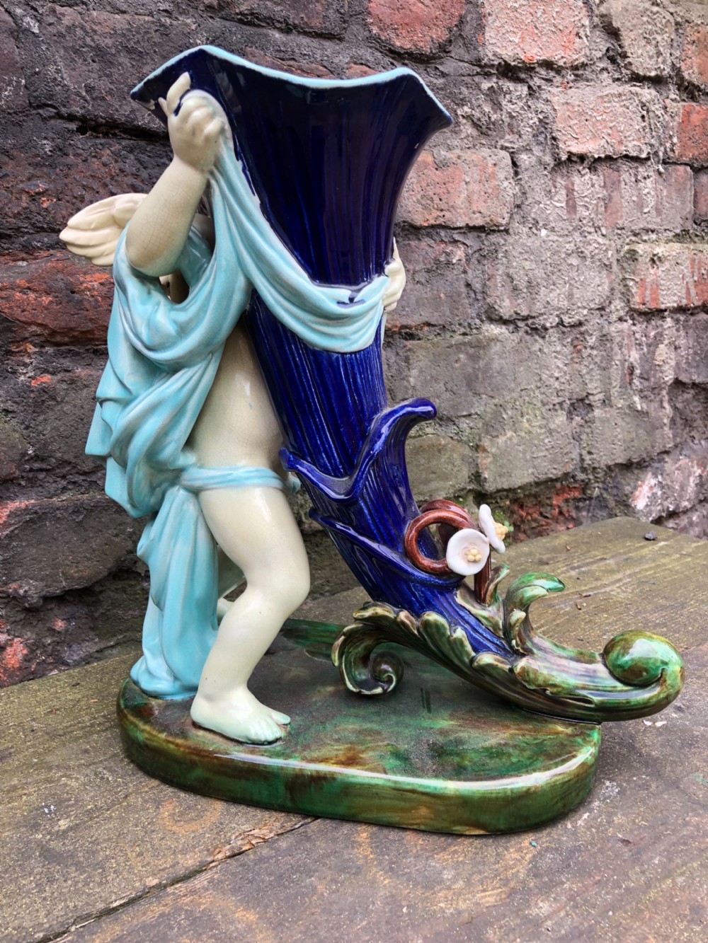 C19th large majolica cherub holding a cornucopia  View III