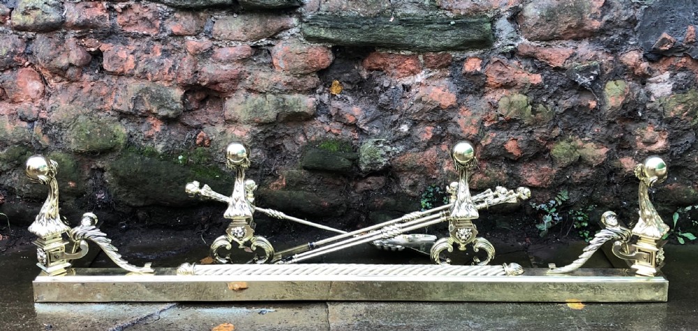 C19th brass fender complete with matching Andirons and fire irons 