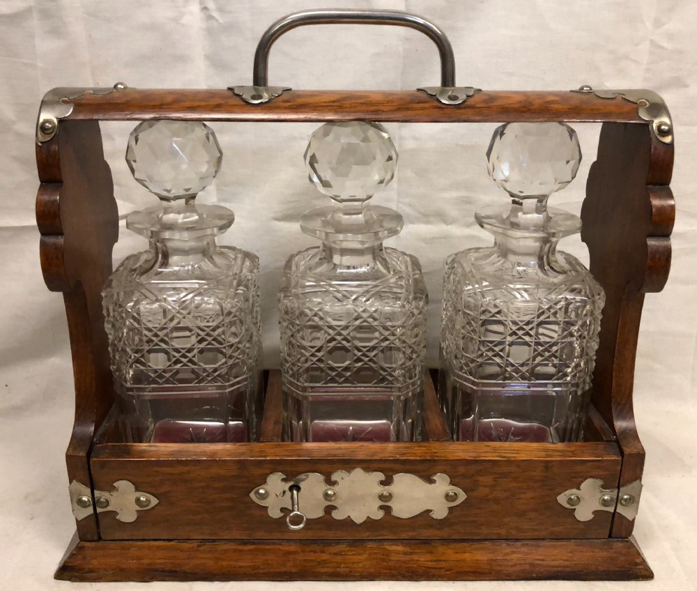 C19th oak and silver plated three bottle tantalus