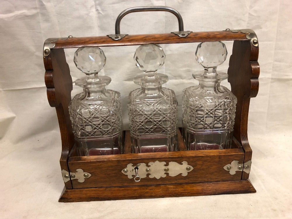 C19th oak and silver plated three bottle tantalus View II
