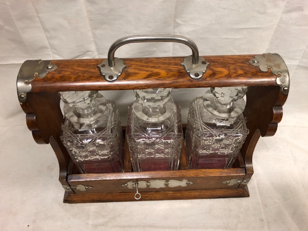 C19th oak and silver plated three bottle tantalus View III