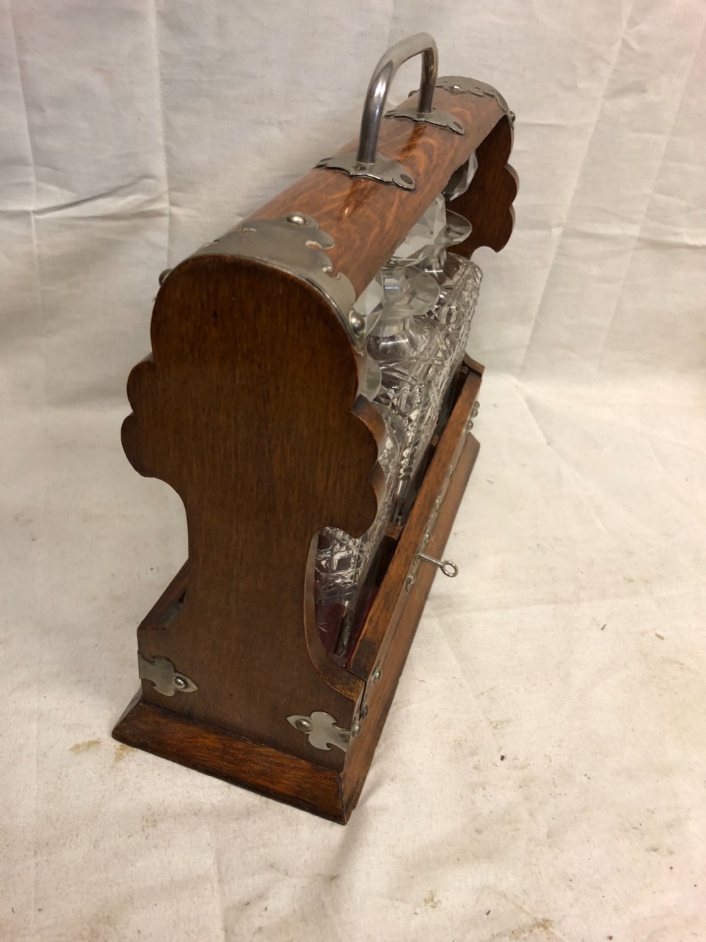 C19th oak and silver plated three bottle tantalus View IV