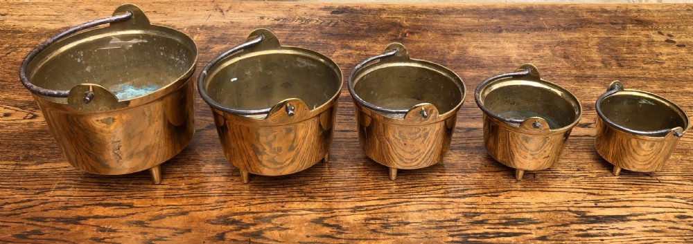 C19th graduating set of 5 brass cooking pans with feet 
