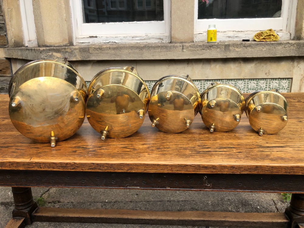 C19th graduating set of 5 brass cooking pans with feet  View IX
