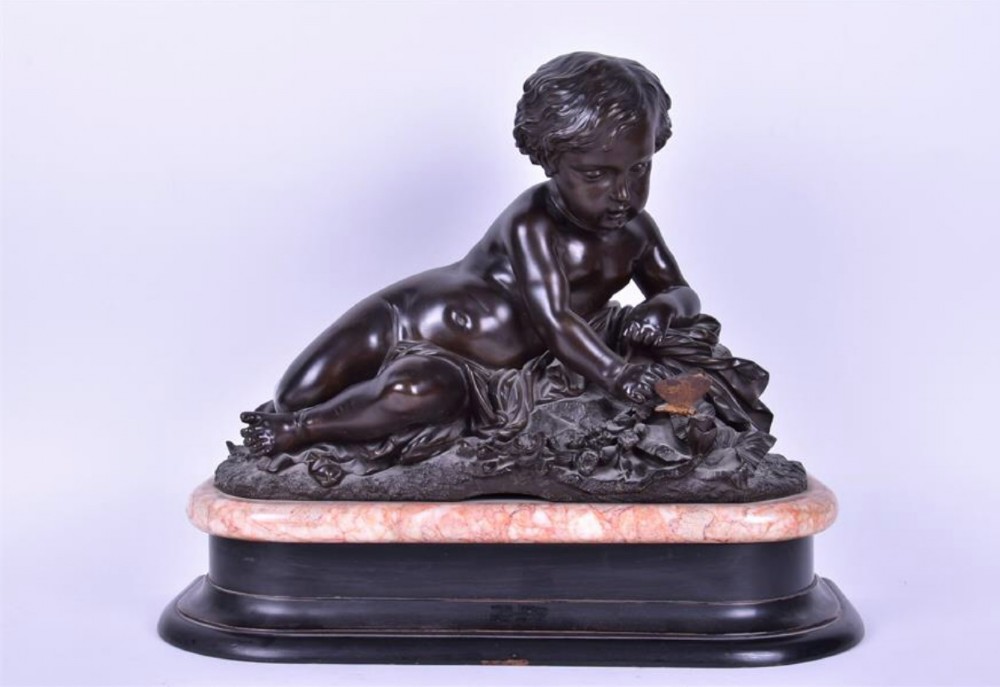 Large C19th continental bronze of reclining cherub on marble base