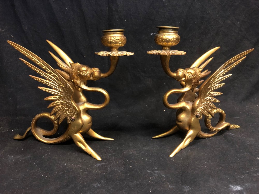 C19tg pair of gilt bronze candlesticks shaped as griffins