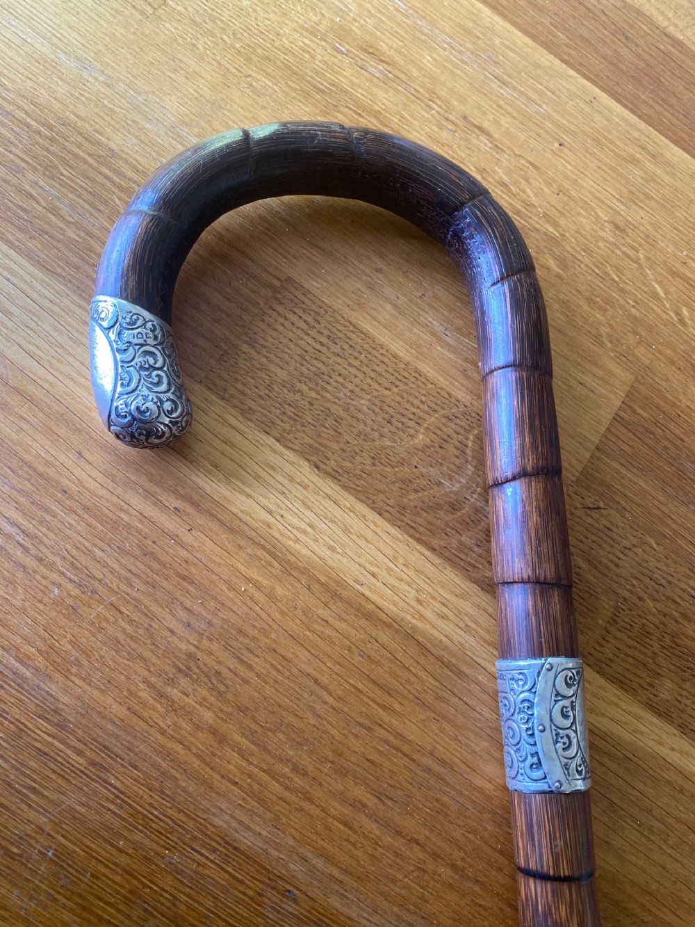 Silver collared and tipped palm wood walking stick
