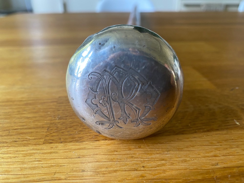 A bulbous white metal topped cane monogrammed RM or MR View III