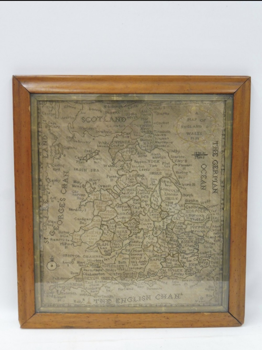 A fine C18th Georgian map sampler in maple frame 