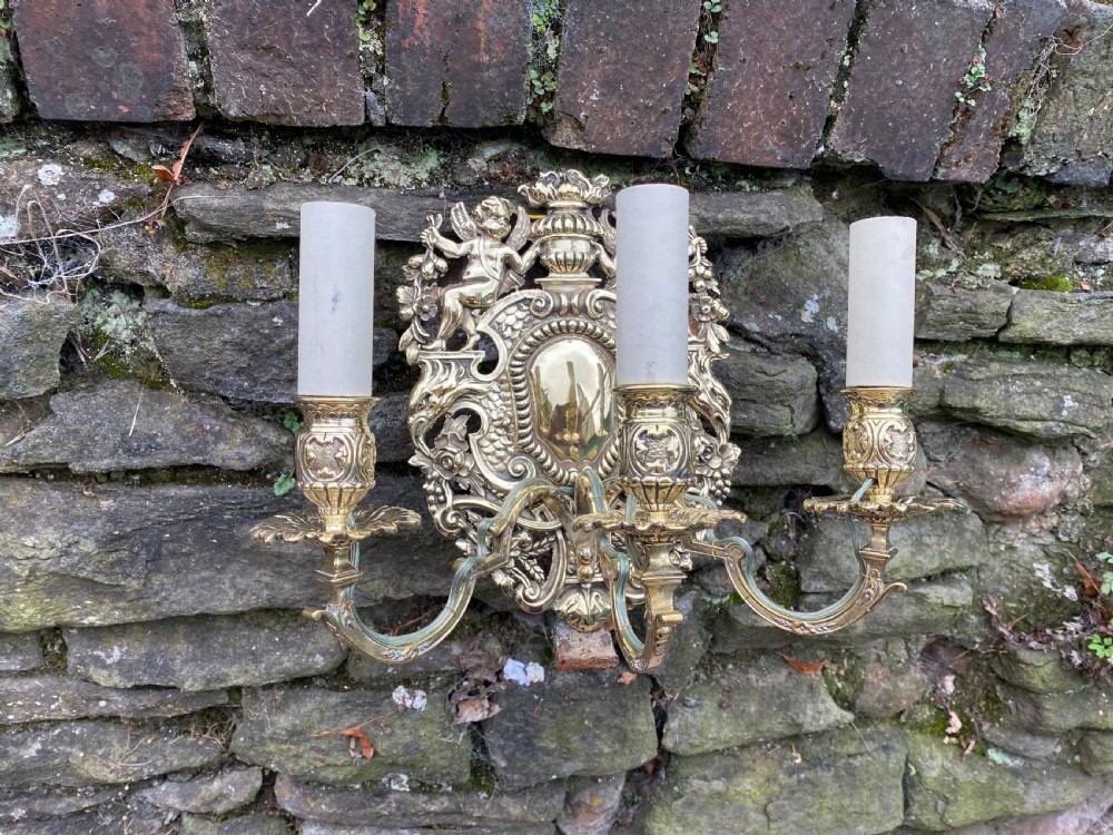 A three armed brass wall light 