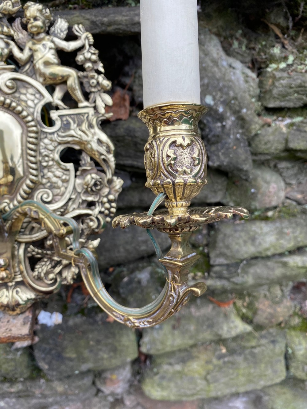 A three armed brass wall light  View V