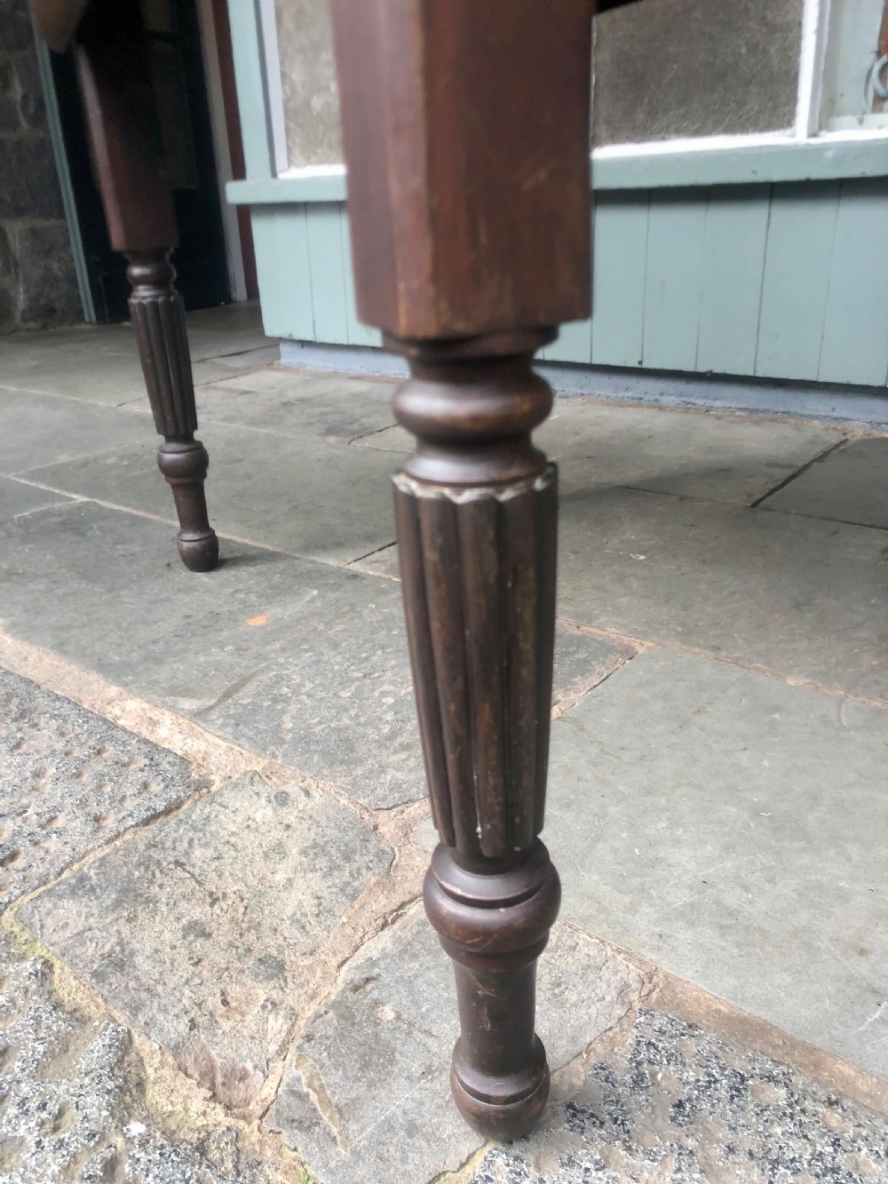 An antique oak chapel table featuring a rectangular drop-leaf top, a single end drawer with a metal handle, and dark turned reeded legs. View V