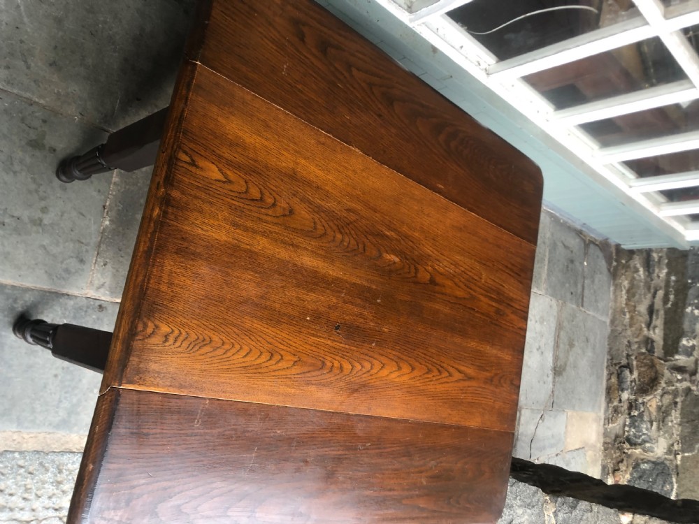 An antique oak chapel table featuring a rectangular drop-leaf top, a single end drawer with a metal handle, and dark turned reeded legs. View VII