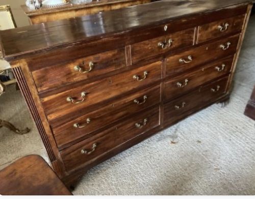 An eighteenth-century mahogany chest of drawers with multiple horizontal drawers fitted with brass swan-neck handles and keyhole escutcheons. View III