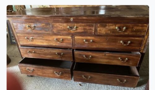 An eighteenth-century mahogany chest of drawers with multiple horizontal drawers fitted with brass swan-neck handles and keyhole escutcheons. View IV