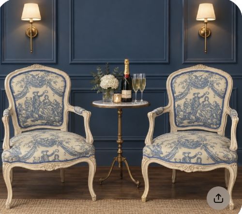 A pair of 19th-century French salon armchairs with off-white painted wooden frames, cabriole legs, and blue pastoral Toile de Jouy pattern upholstery. View VI