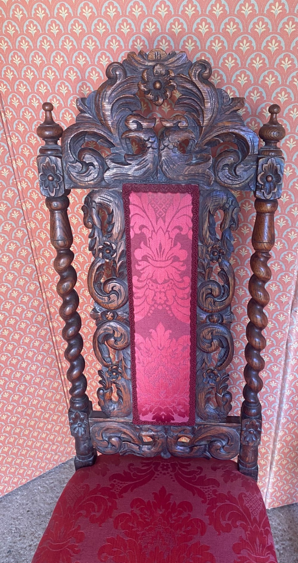 A pair of high-backed carved oak hall chairs featuring elaborate scrollwork, barley twist pillars, and red pattern damask upholstery. View IV