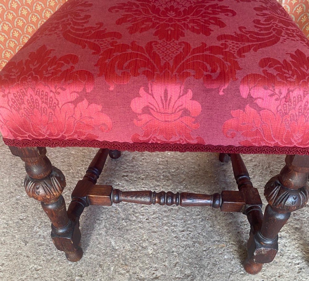 A pair of high-backed carved oak hall chairs featuring elaborate scrollwork, barley twist pillars, and red pattern damask upholstery. View VIII