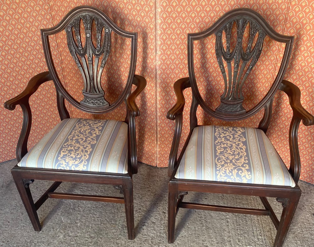 Set of eight mahogany Regency dining chairs featuring openwork carved shield backs and patterned upholstered seats. View IV