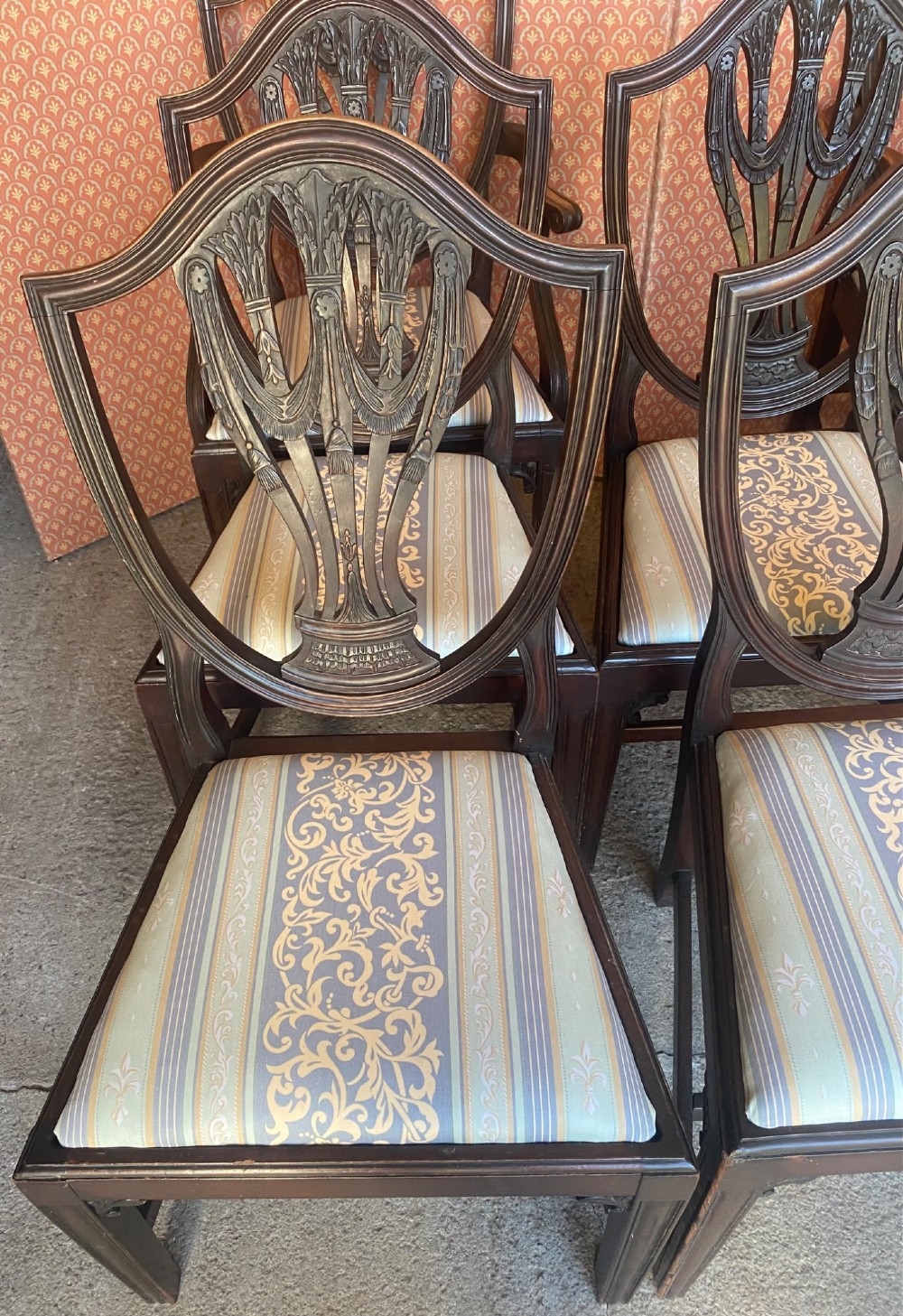 Set of eight mahogany Regency dining chairs featuring openwork carved shield backs and patterned upholstered seats. View V