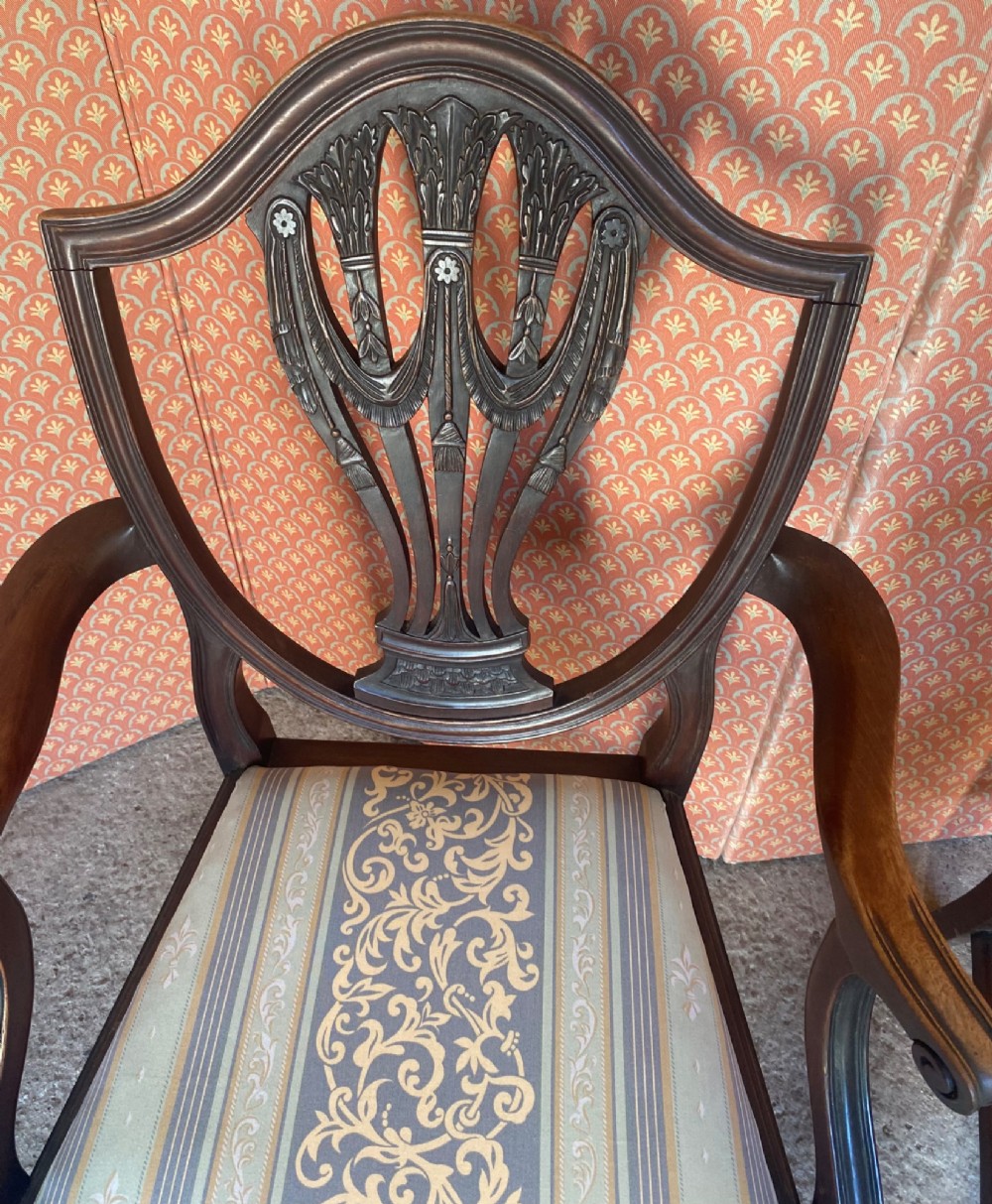 Set of eight mahogany Regency dining chairs featuring openwork carved shield backs and patterned upholstered seats. View VII