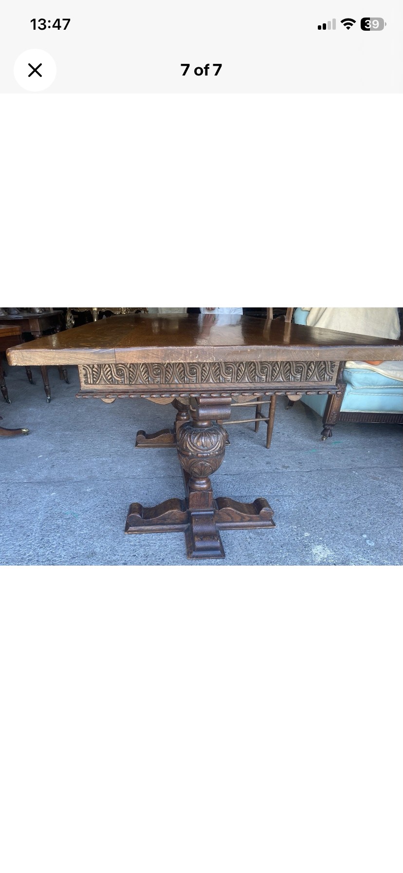 A rectangular solid oak refectory dining table featuring a carved frieze, carved bulbous turned legs, and a low stretcher base. View VI
