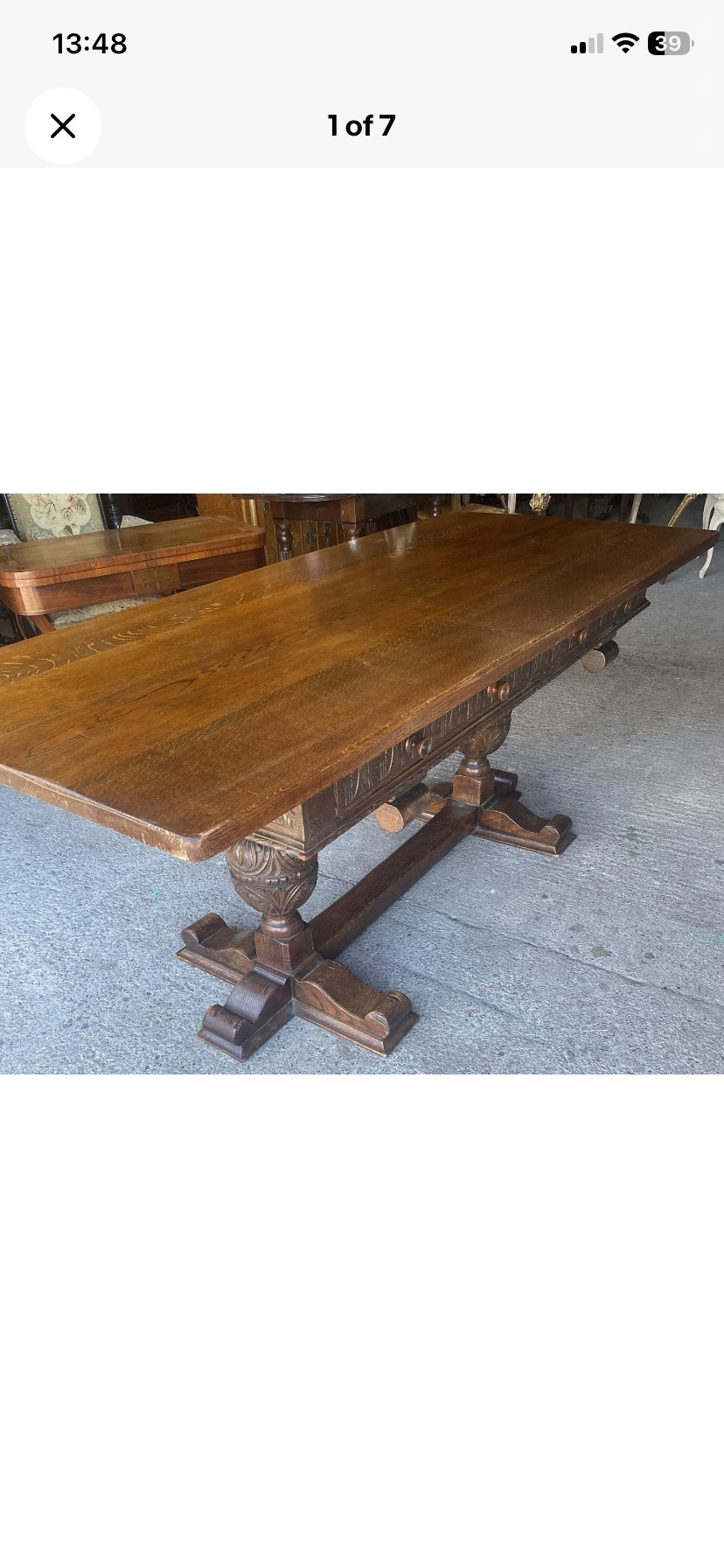 A rectangular solid oak refectory dining table featuring a carved frieze, carved bulbous turned legs, and a low stretcher base. View VIII