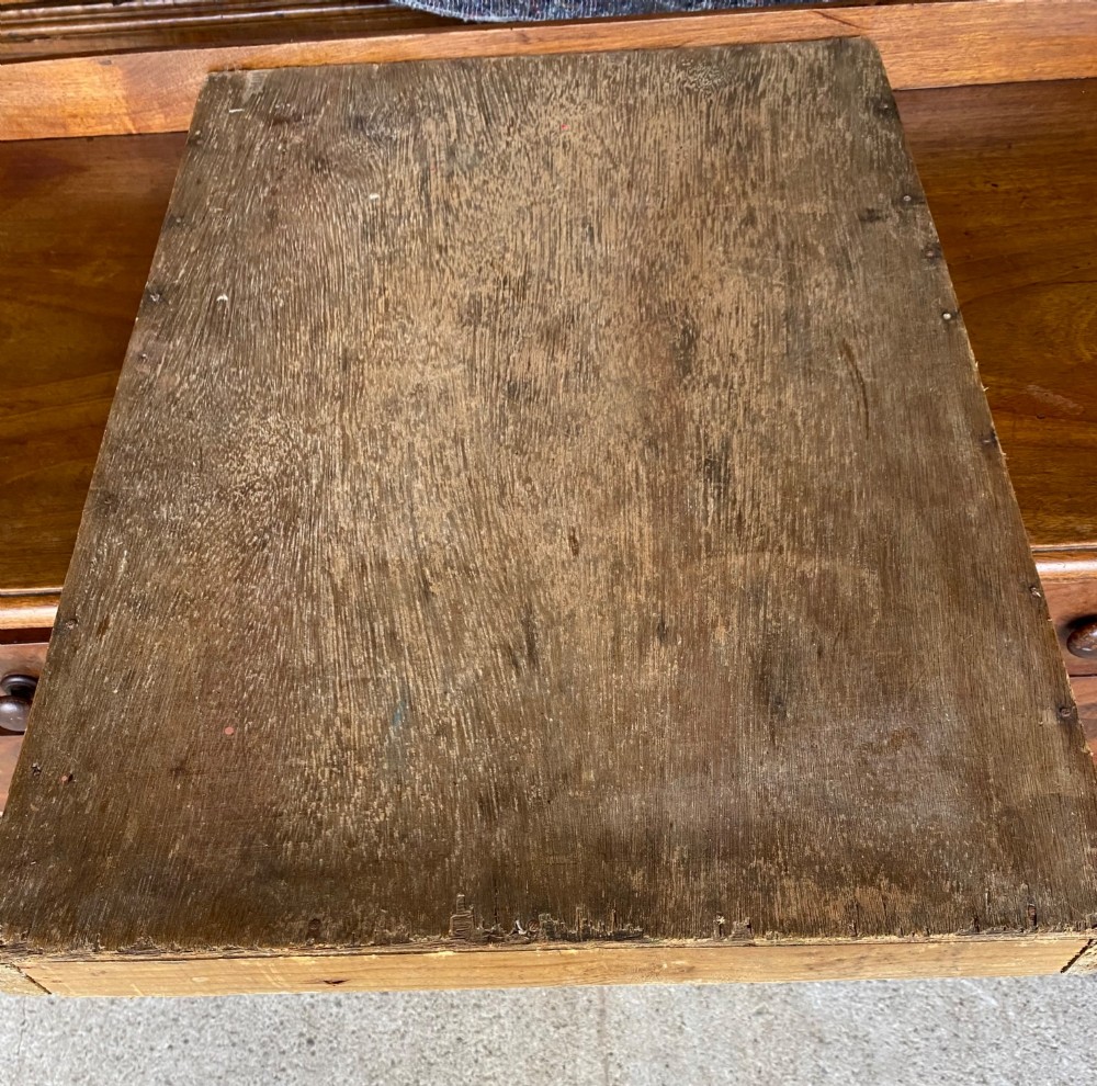 A rectangular dark grey slate shove hapenny board incised with horizontal scoring lines and several brass tokens. View II
