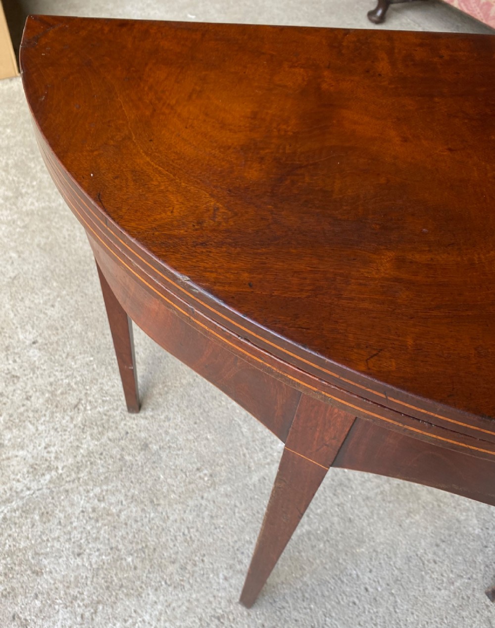 An 18th-century mahogany demilune tea table featuring a semi-circular fold-over top and four slender tapered legs. View III