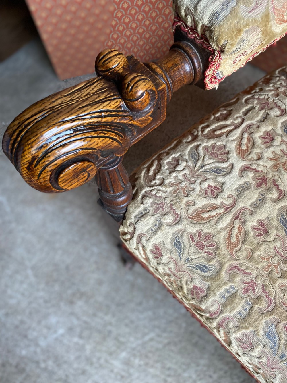 A 19th-century carved dark oak armchair with an oval upholstered backrest, ornate leaf cresting, and scrolled armrests. View III