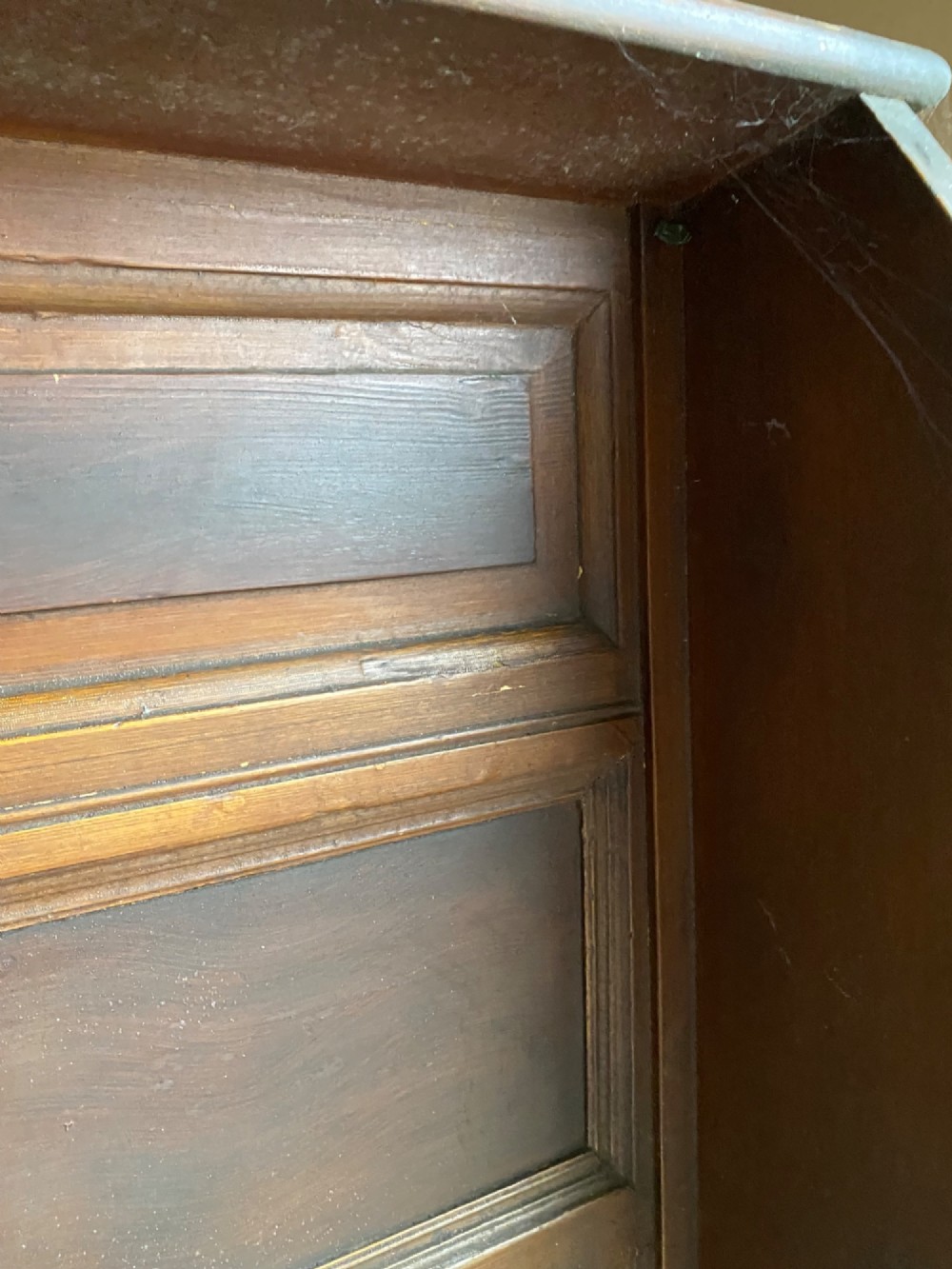 An 18th-century high-backed wooden settle featuring multi-panelled backboards, wing sides, and a lift-up box seat base with rich brown patina. View IV