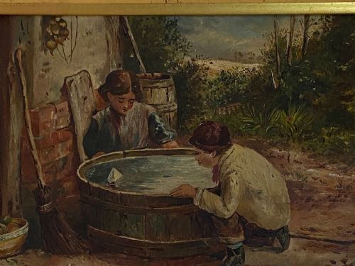 fig 2. An 1884 Victorian oil painting on canvas by Albert-Ernest Brockbank depicting children playing with a toy boat in a water tub inside a broad gold gilt frame.