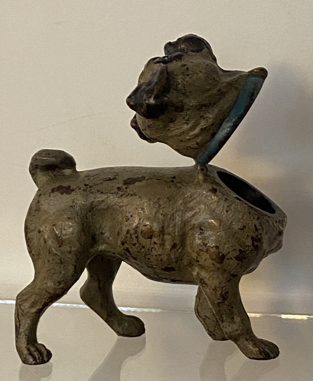 An antique cold-painted bronze desk inkwell designed in the realistic form of a standing pug dog with a blue collar. View V