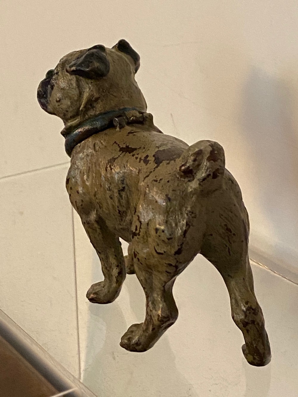 An antique cold-painted bronze desk inkwell designed in the realistic form of a standing pug dog with a blue collar. View VII